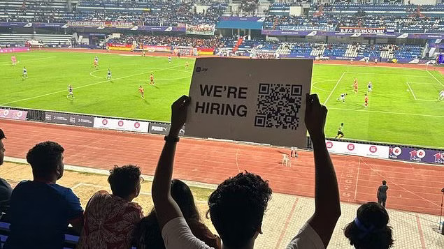 Were hiring placard held in Bengaluru ISL Match