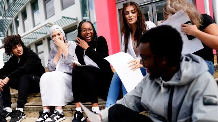 UK exam boards make sharp cuts to top A-level grades